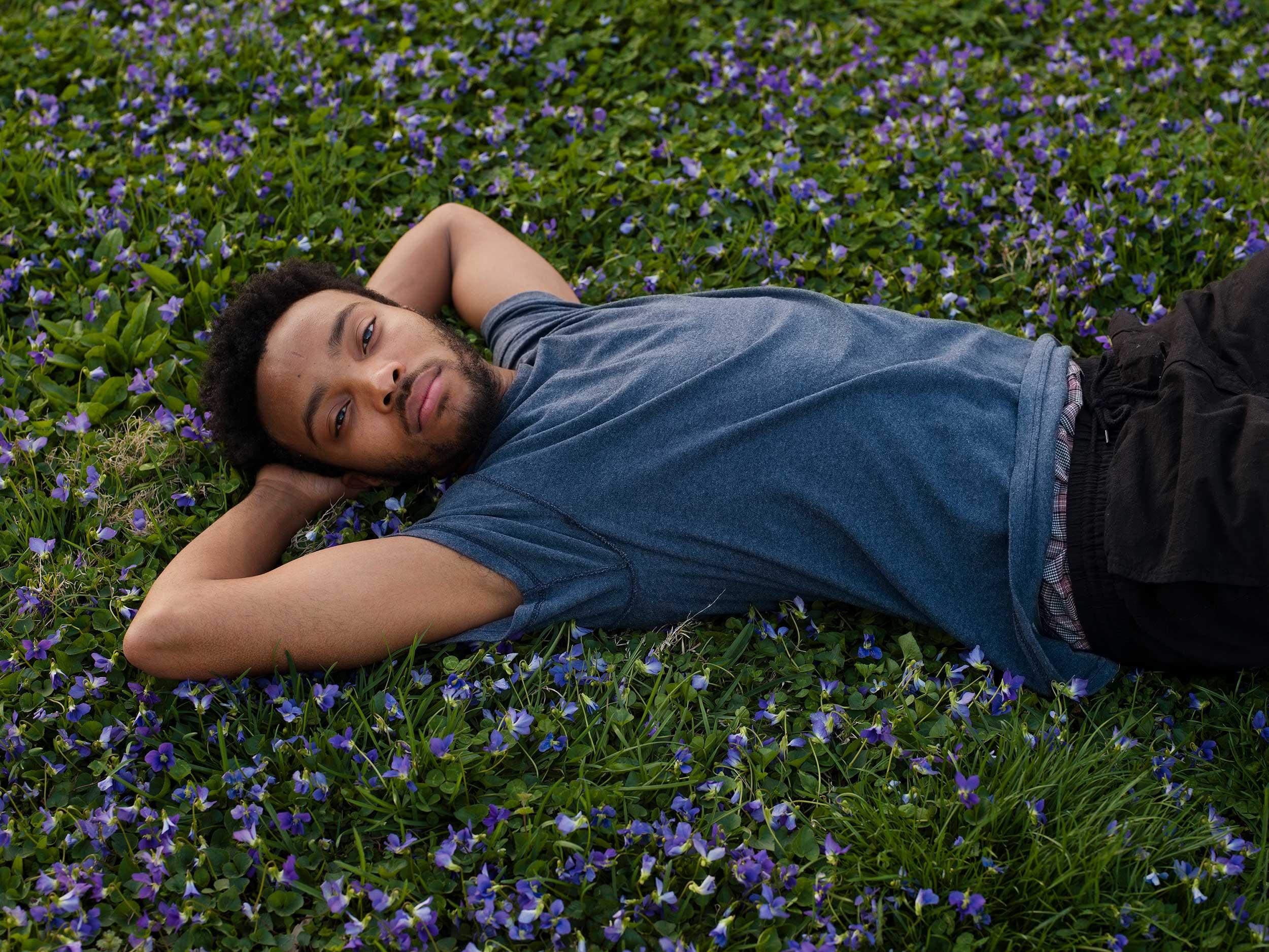 A man relaxing on the grass.
