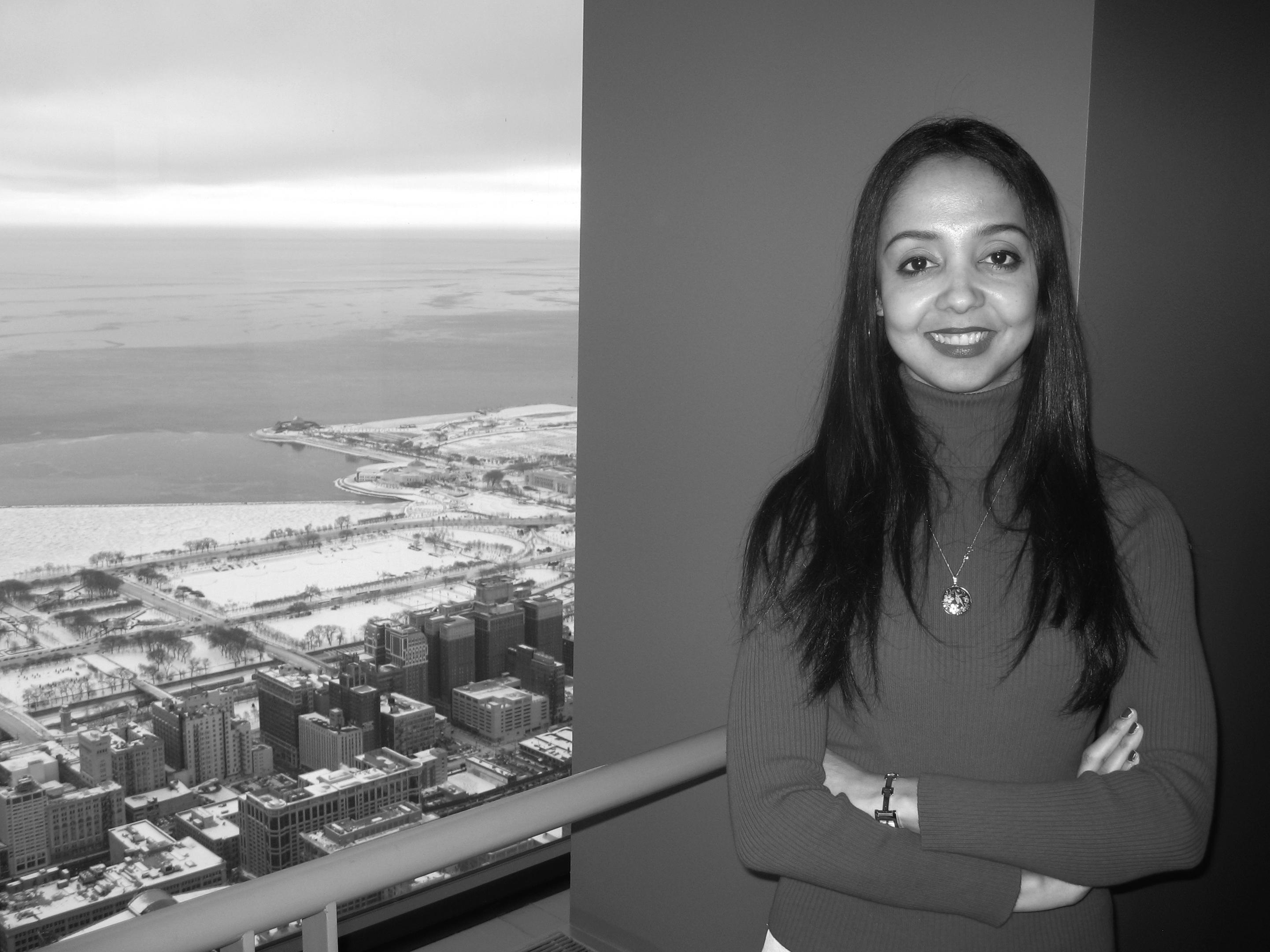 A girl posing next to a balcony.