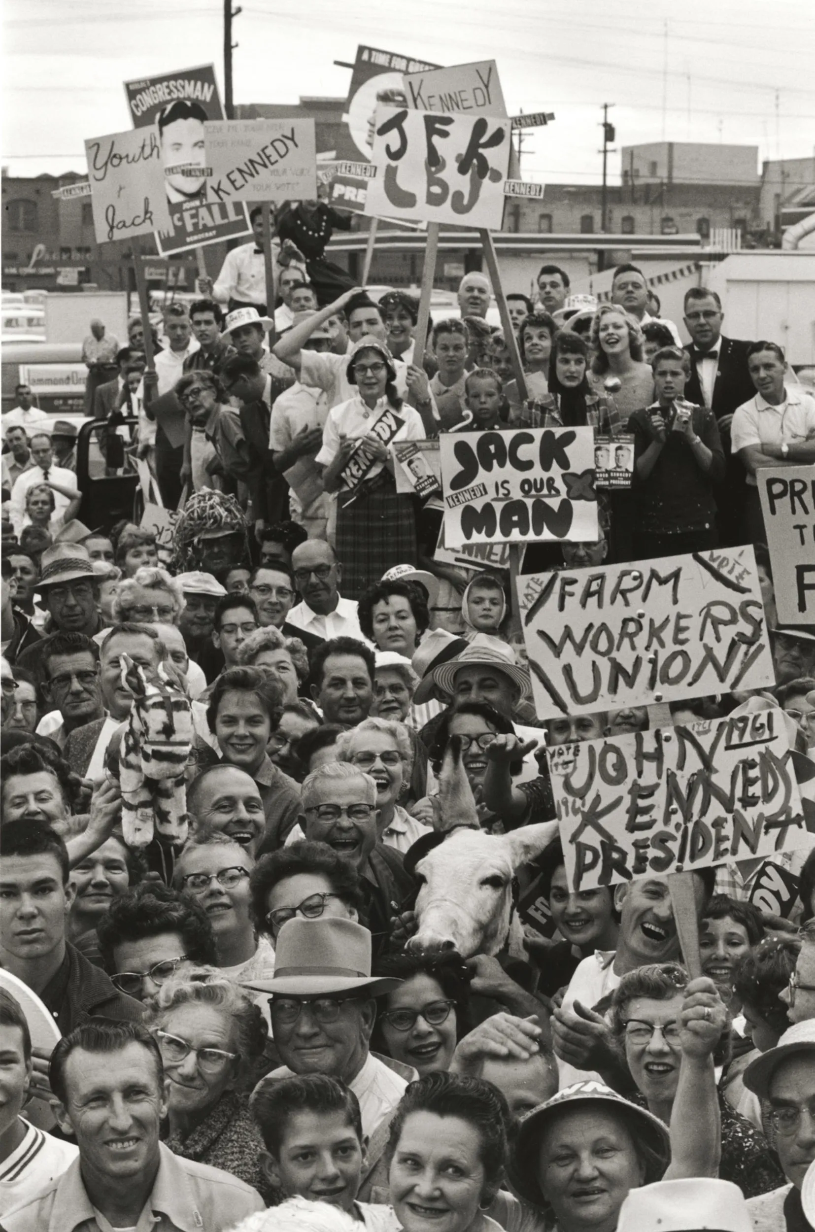 Black and white photograph of crowd of people holding signs at a rally