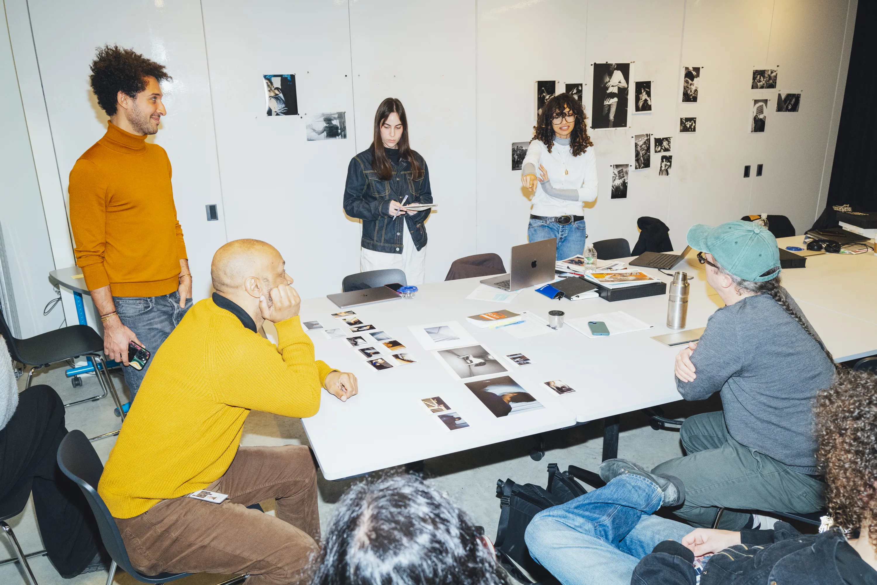 Students look at photos together in classroom