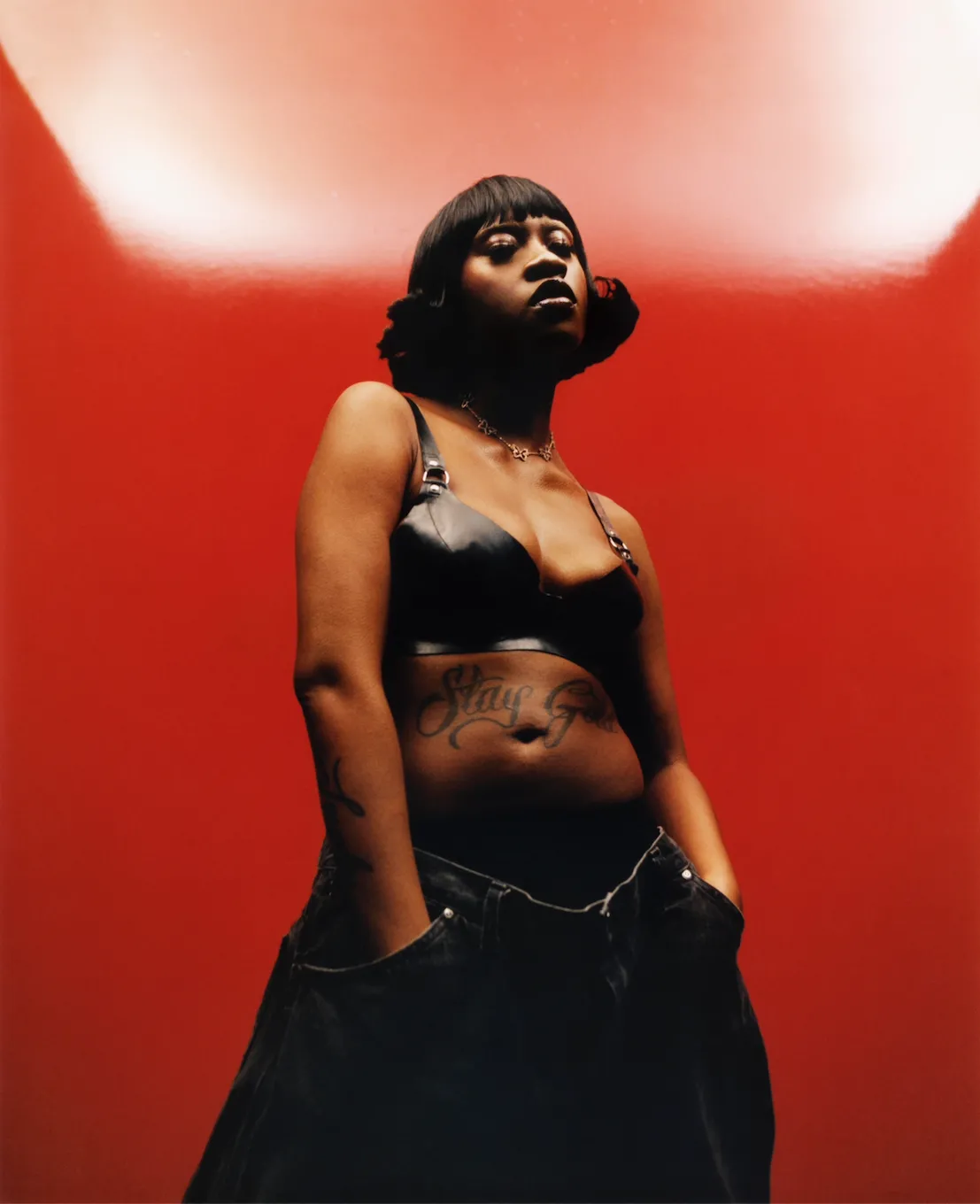 model standing in front of red background